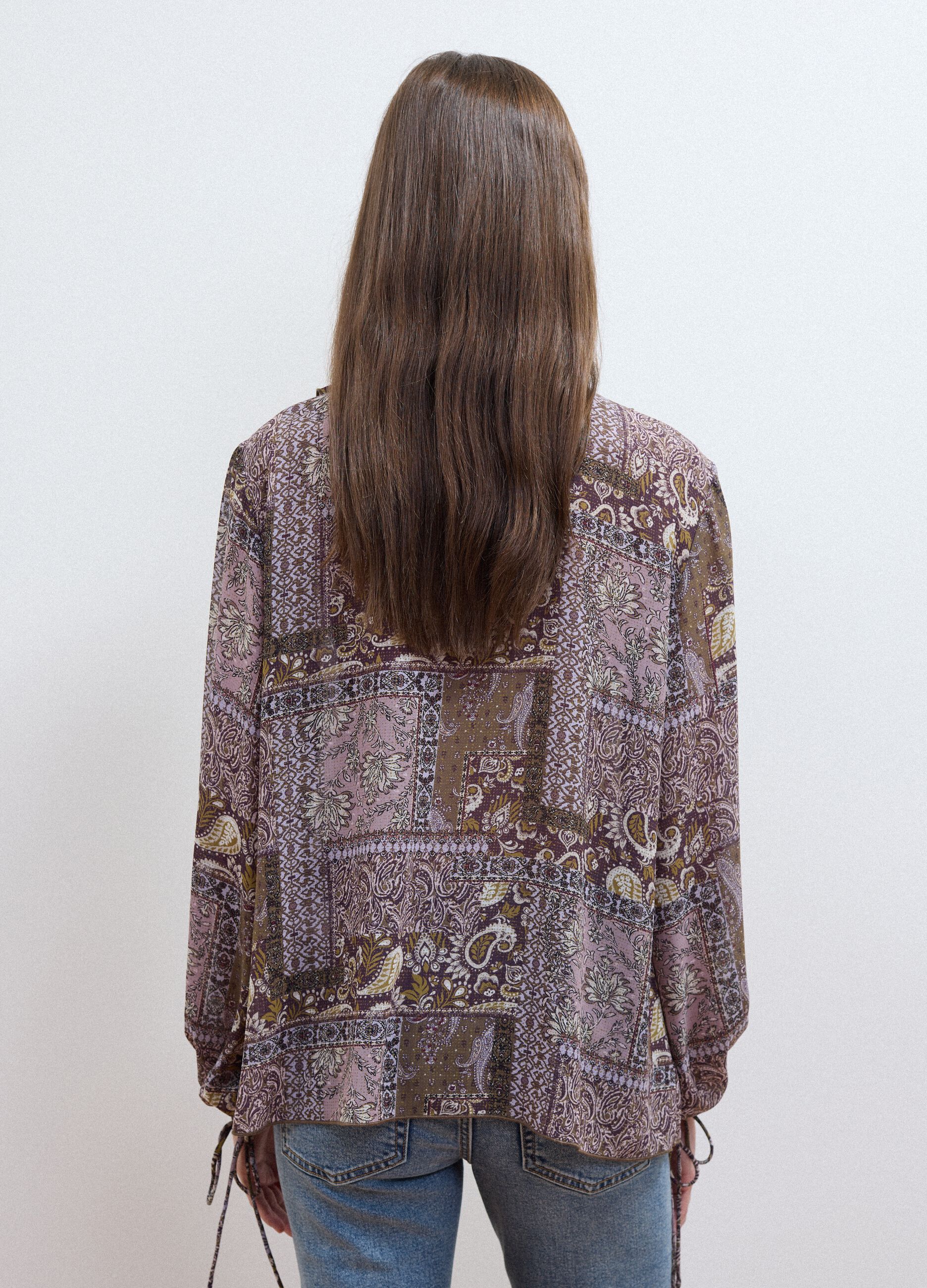 Purple patterned blouse with ruffles and tie neck