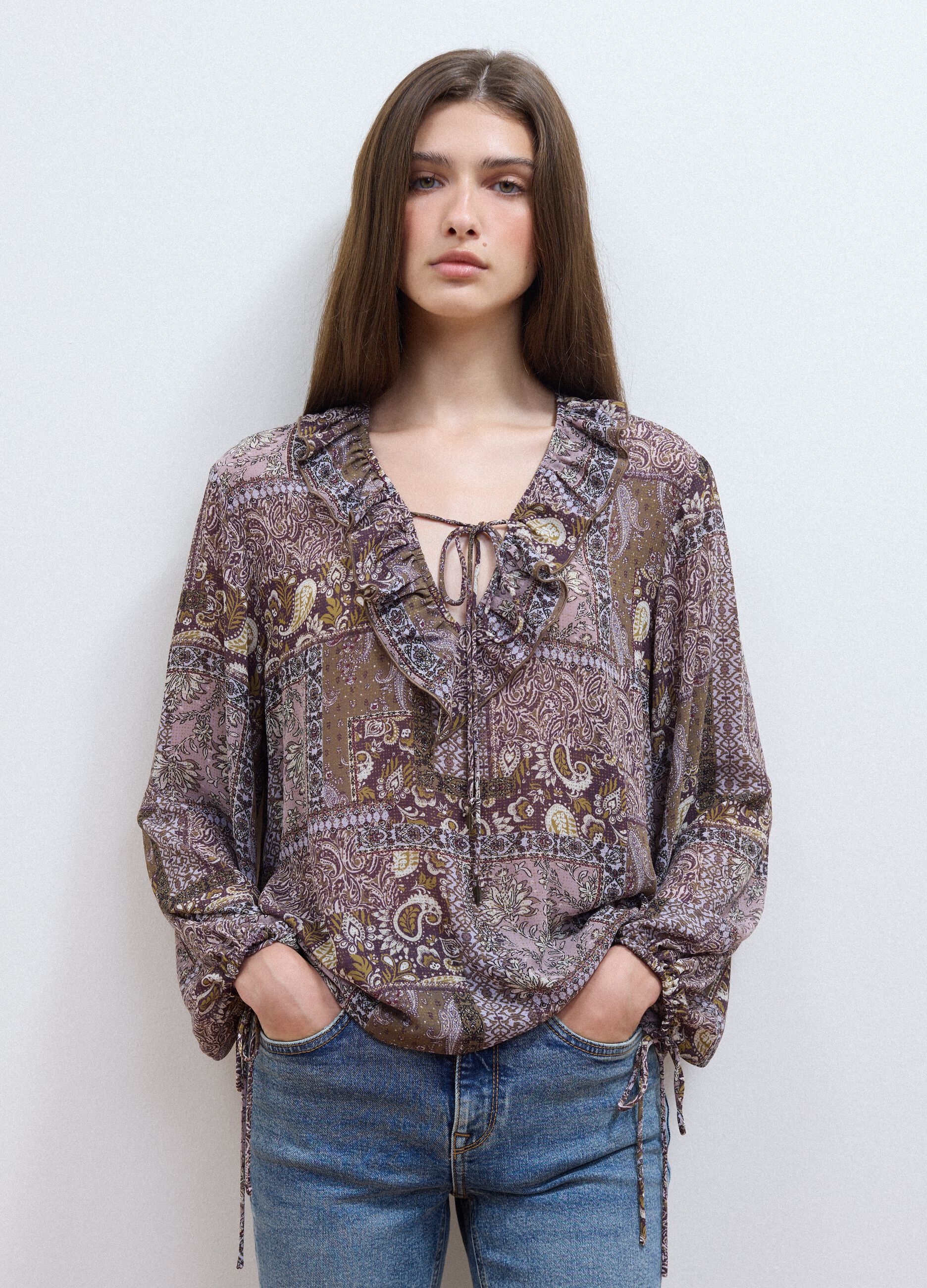 Purple patterned blouse with ruffles and tie neck