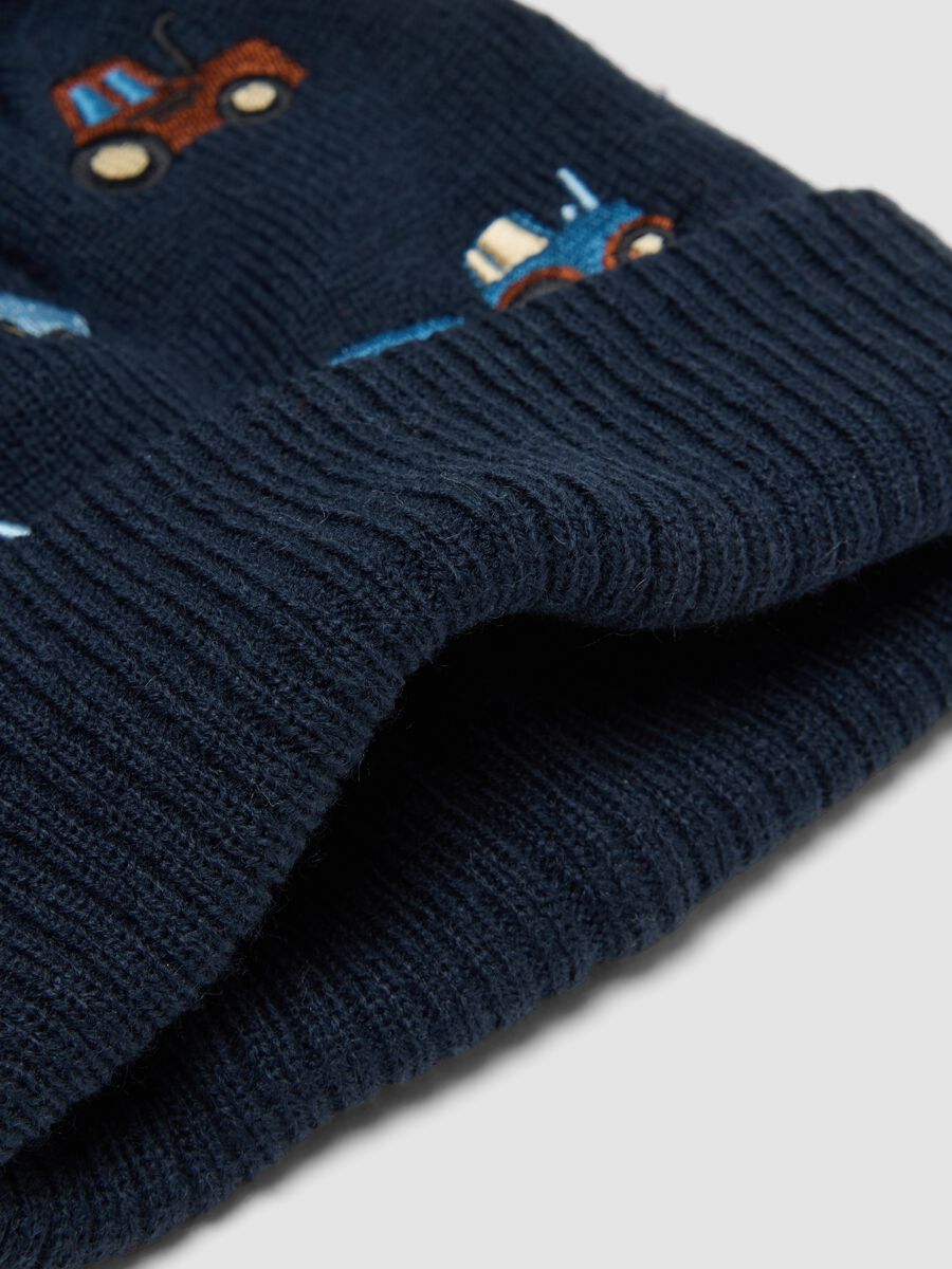 Blue knitted hat with pompom and tractor embroidery_1
