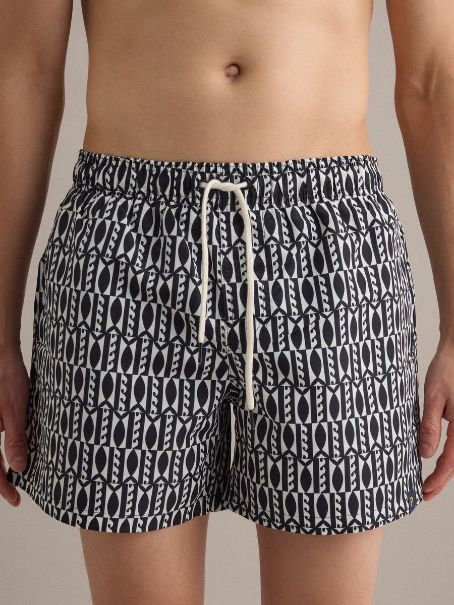 Blue swim shorts with graphic print_1