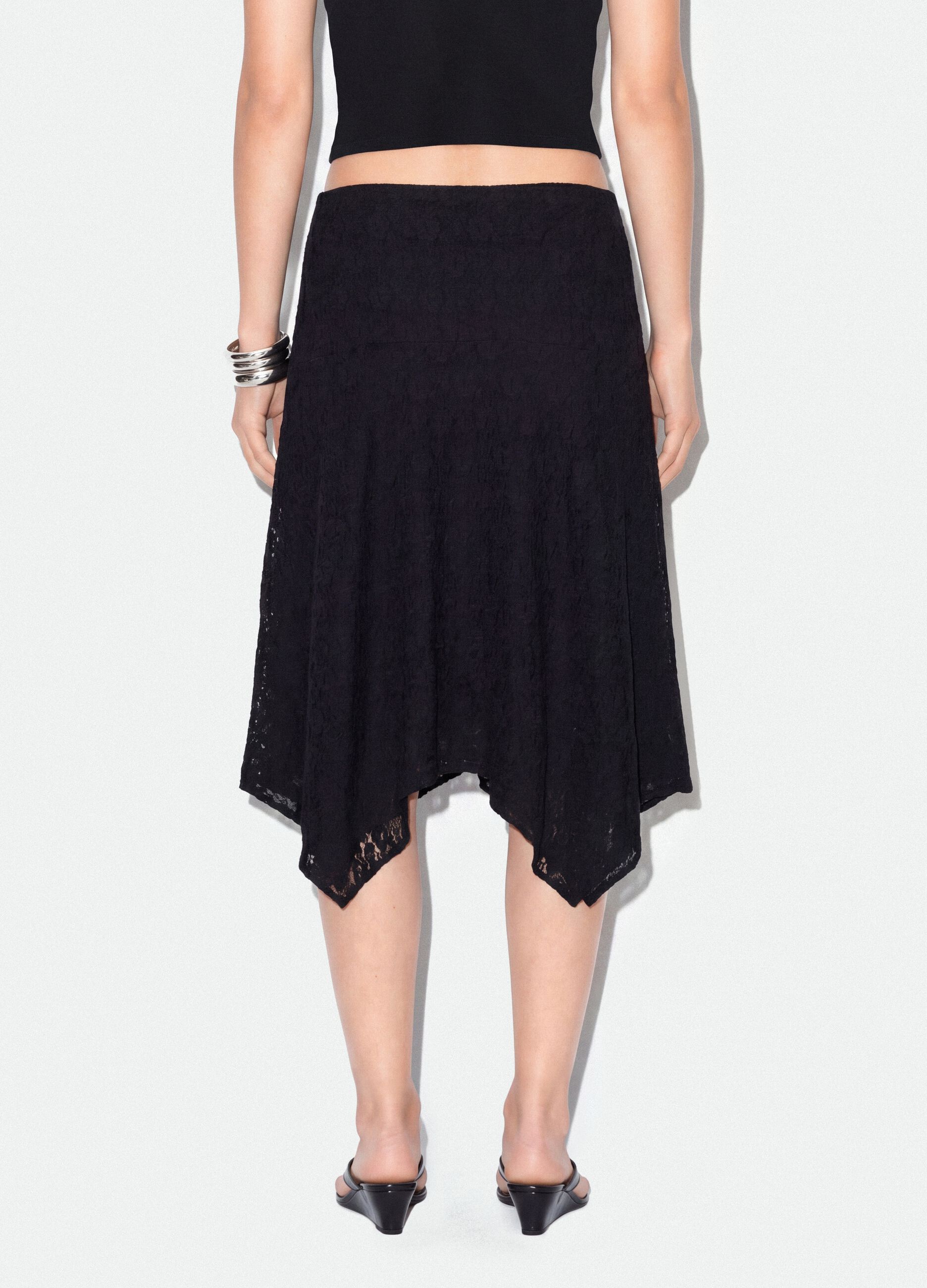 Black stretch skirt with asymmetric lace hem