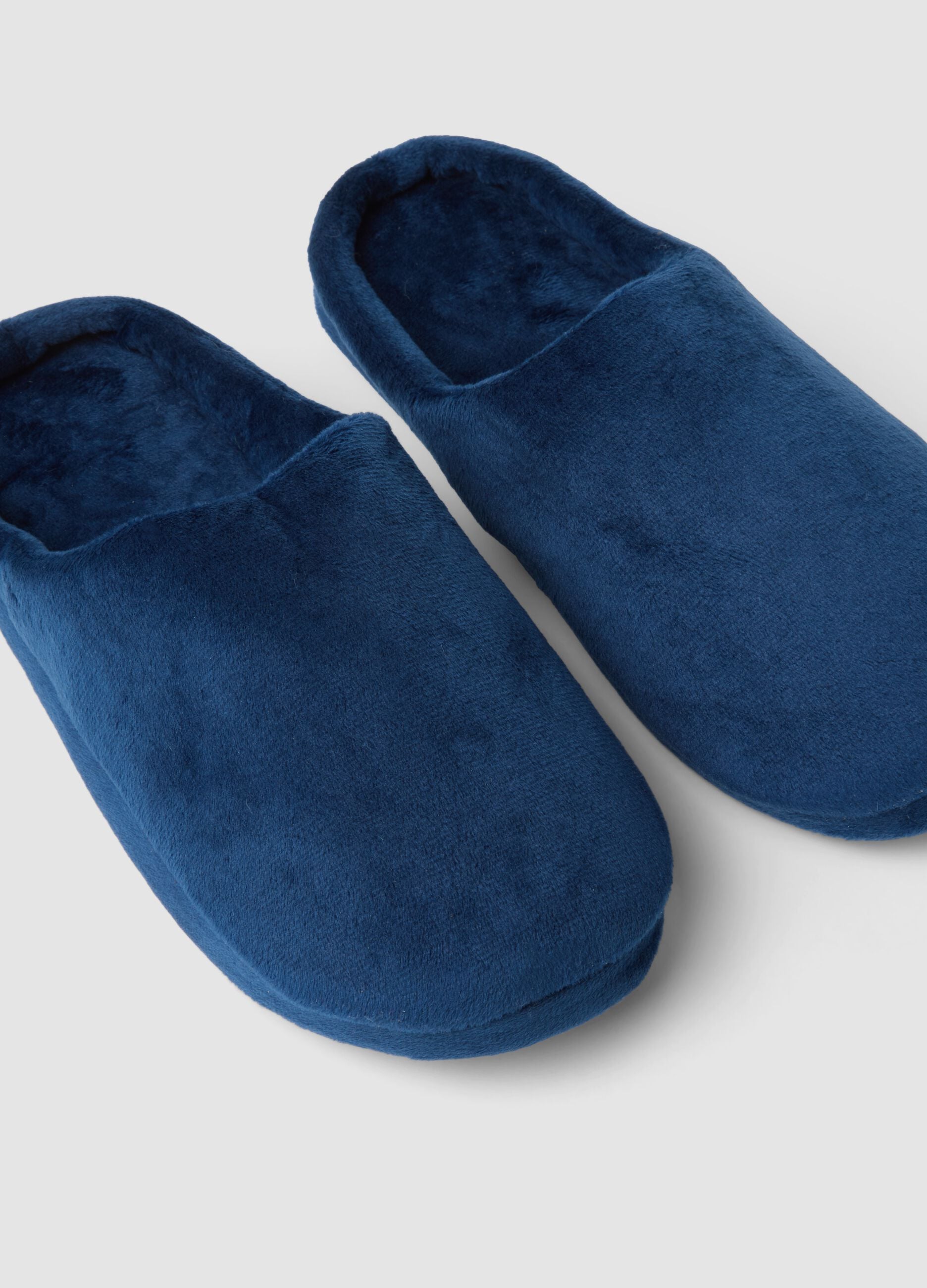 Blue closed-toe slippers with a soft-touch finish
