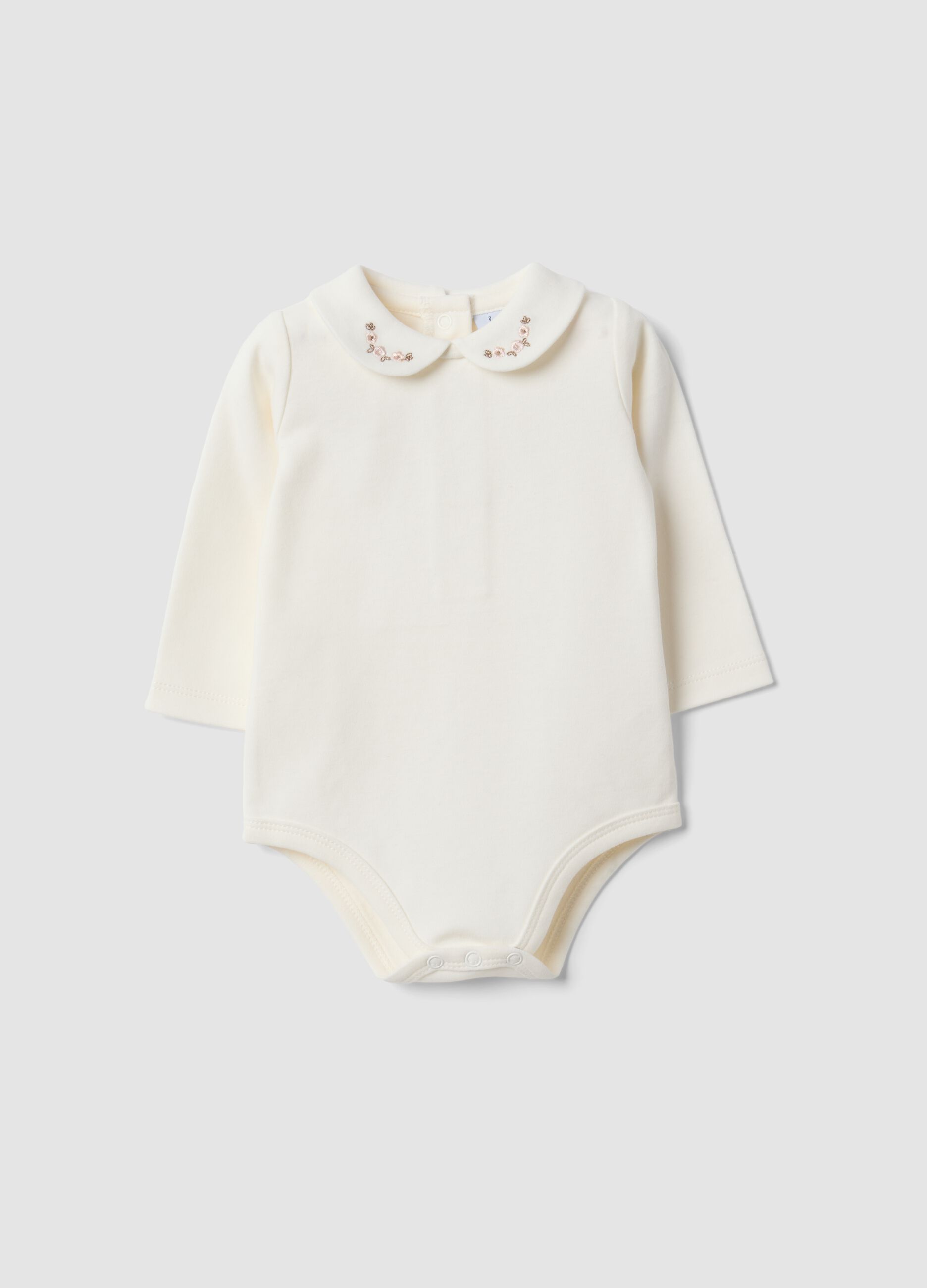 Body bianco in puro cotone organico con ricami floreali per neonata