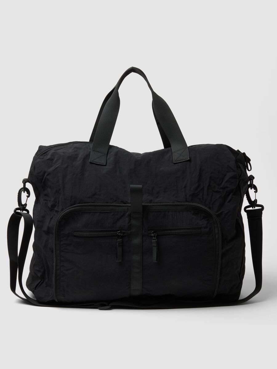 Black foldable travel bag with shoulder strap and zipped pockets_0