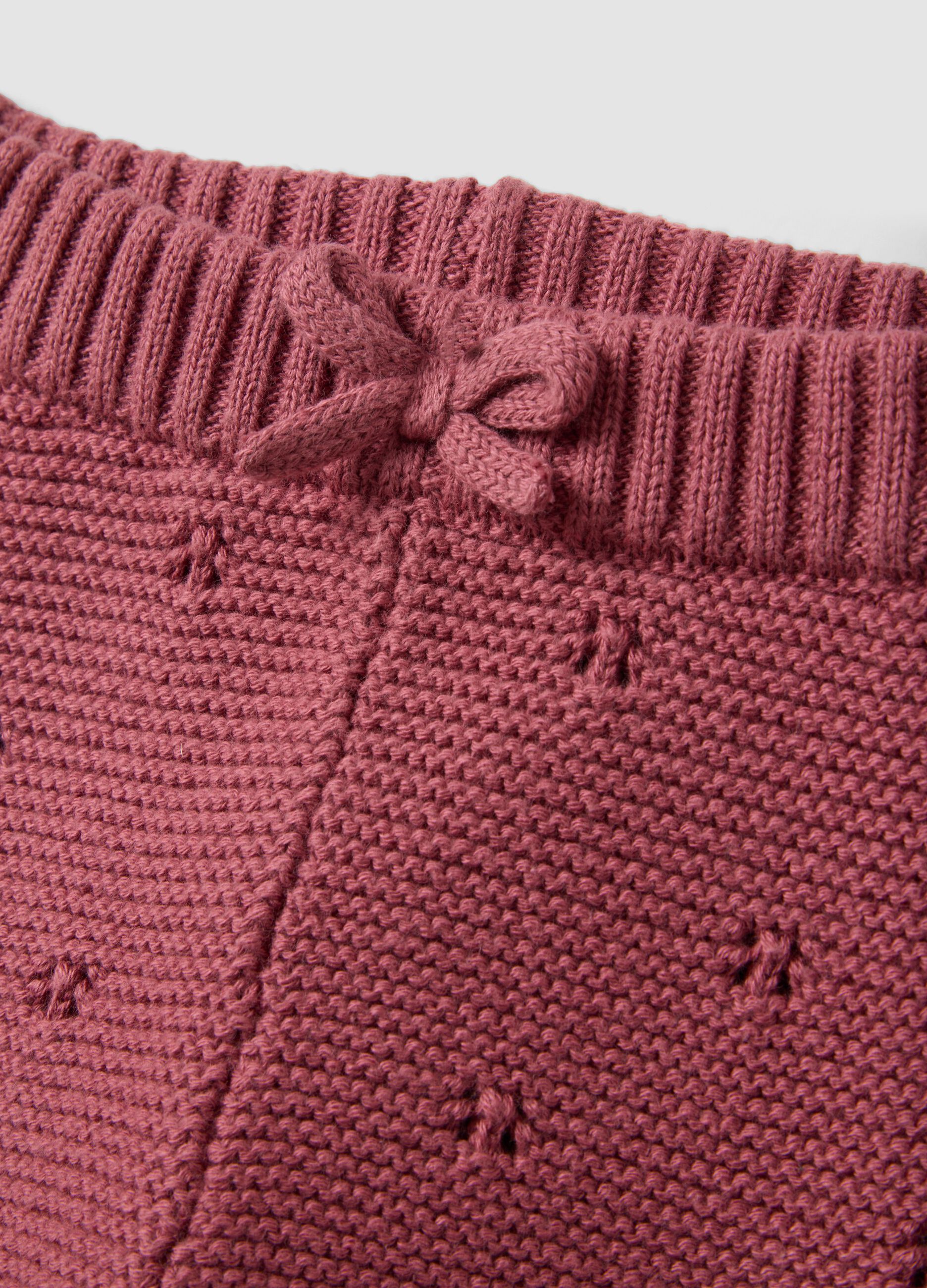 Completo rosa in puro cotone organico in maglia traforata per neonata