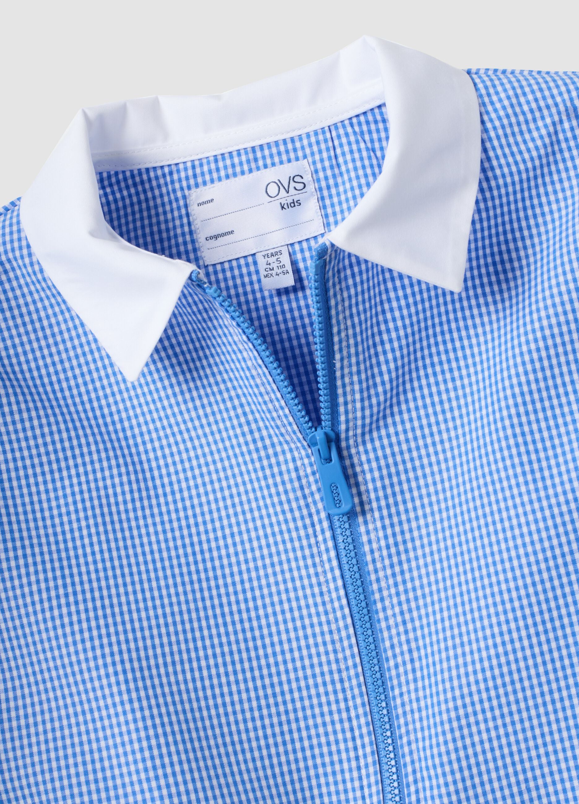 Blue gingham nursery apron with zip and animal embroidery