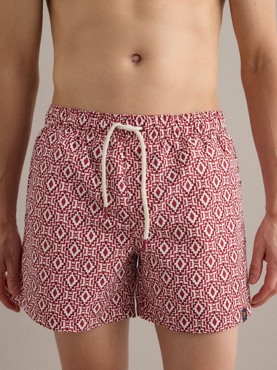 Red swim shorts with geometric print_1
