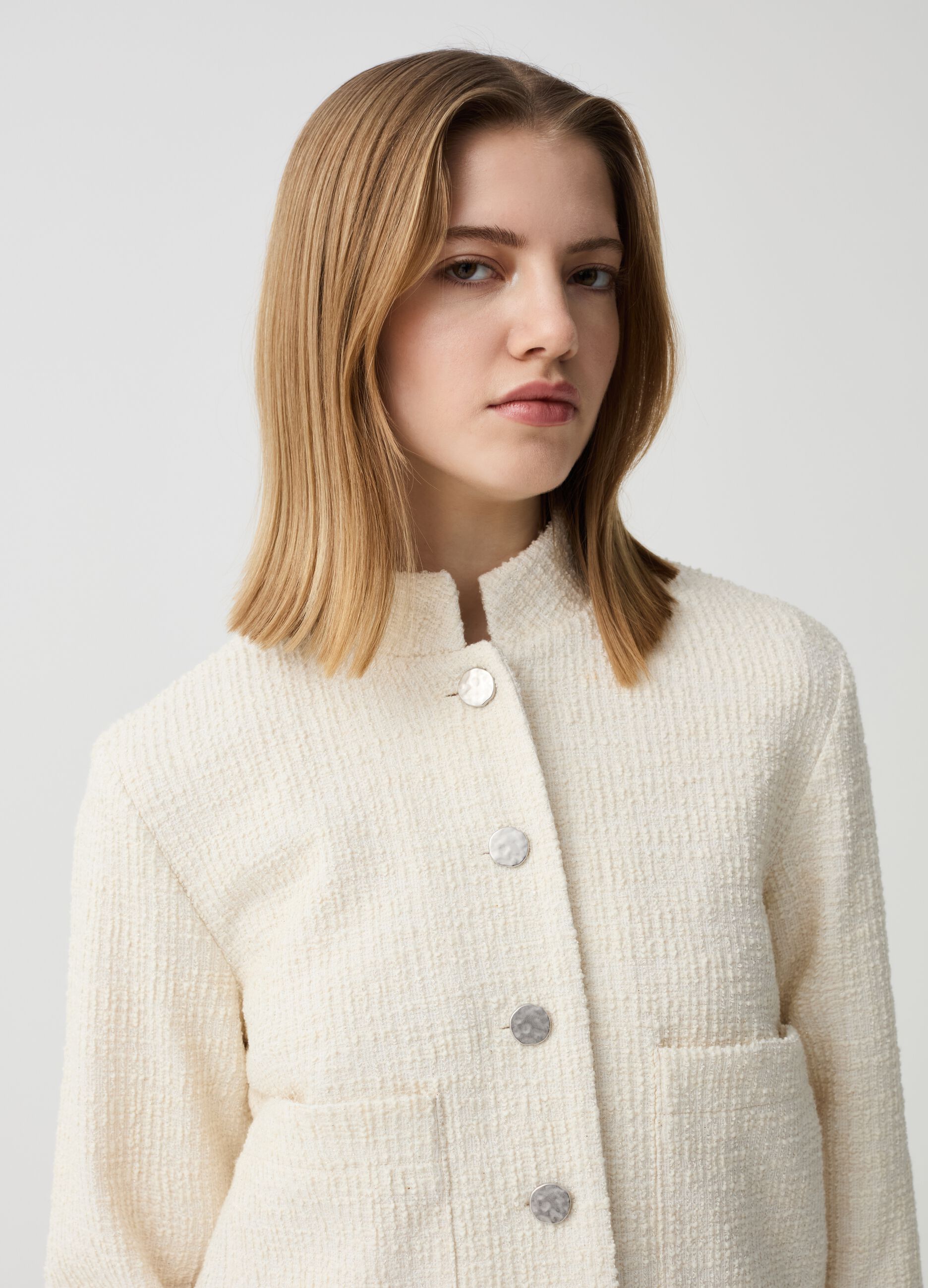Short jacket in lurex with raised weave