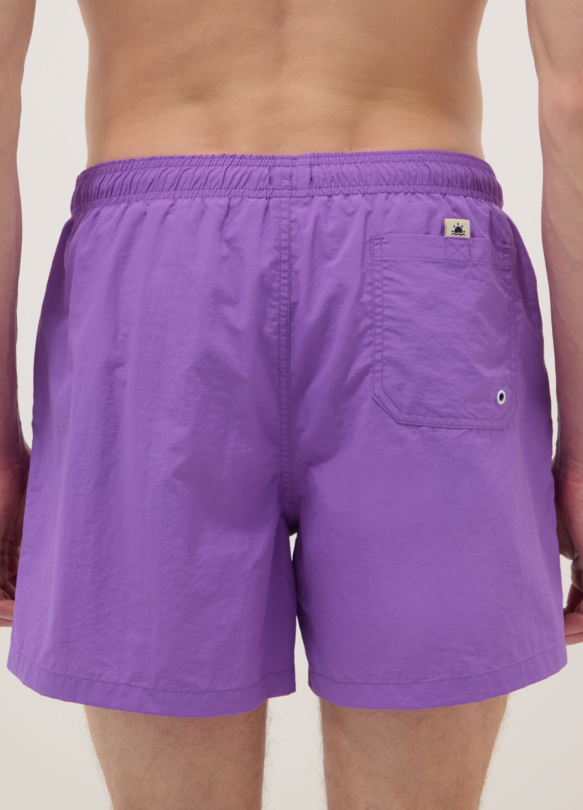 Purple swim shorts with elasticated waistband