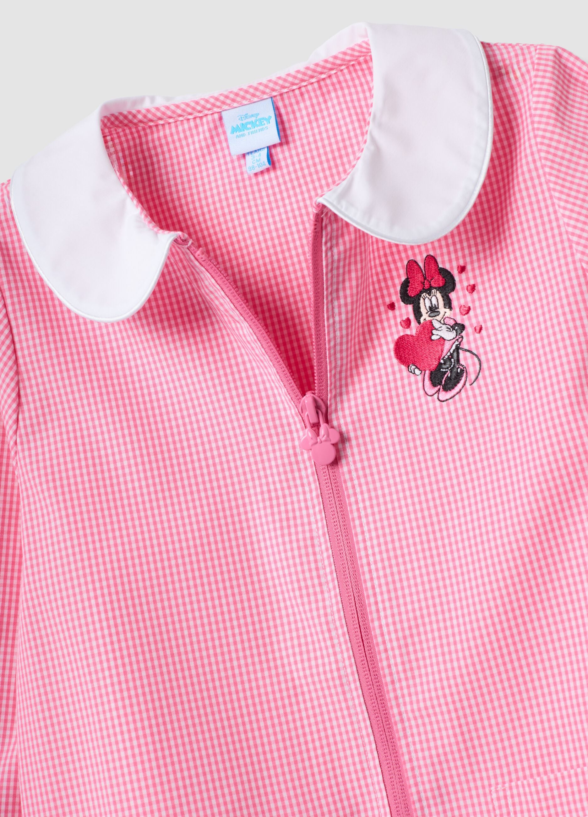 Pink gingham nursery apron with white collar and Minnie embroidery