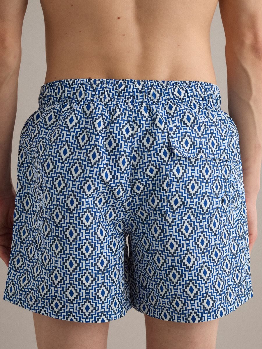 Blue swim shorts with geometric print_4