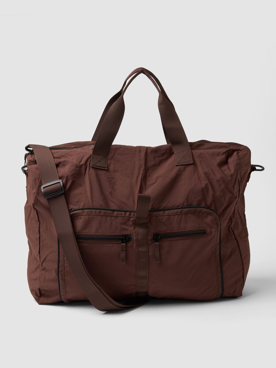 Brown foldable travel bag with shoulder strap and zip pockets_0