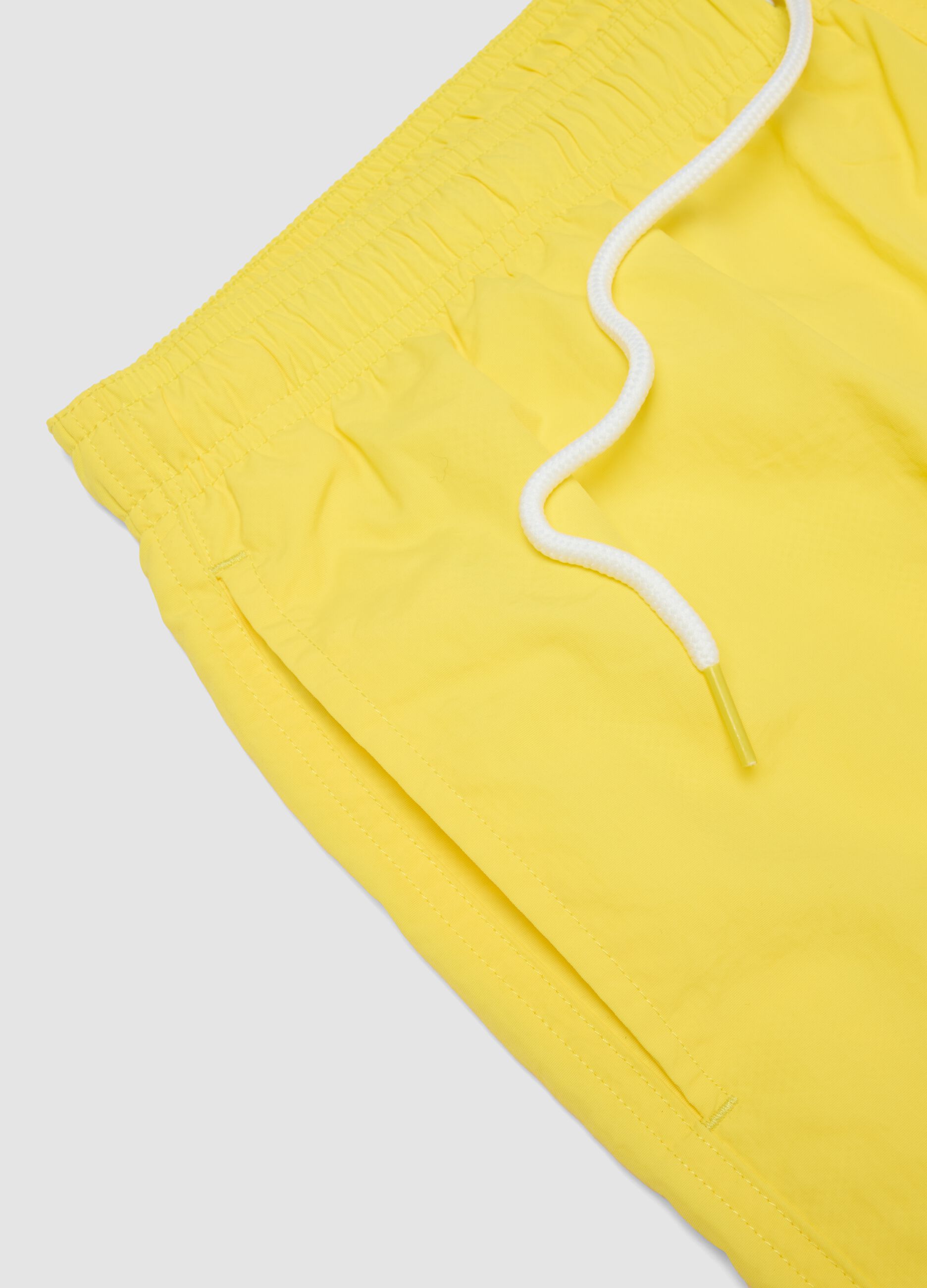 Yellow swim shorts with elasticated waistband