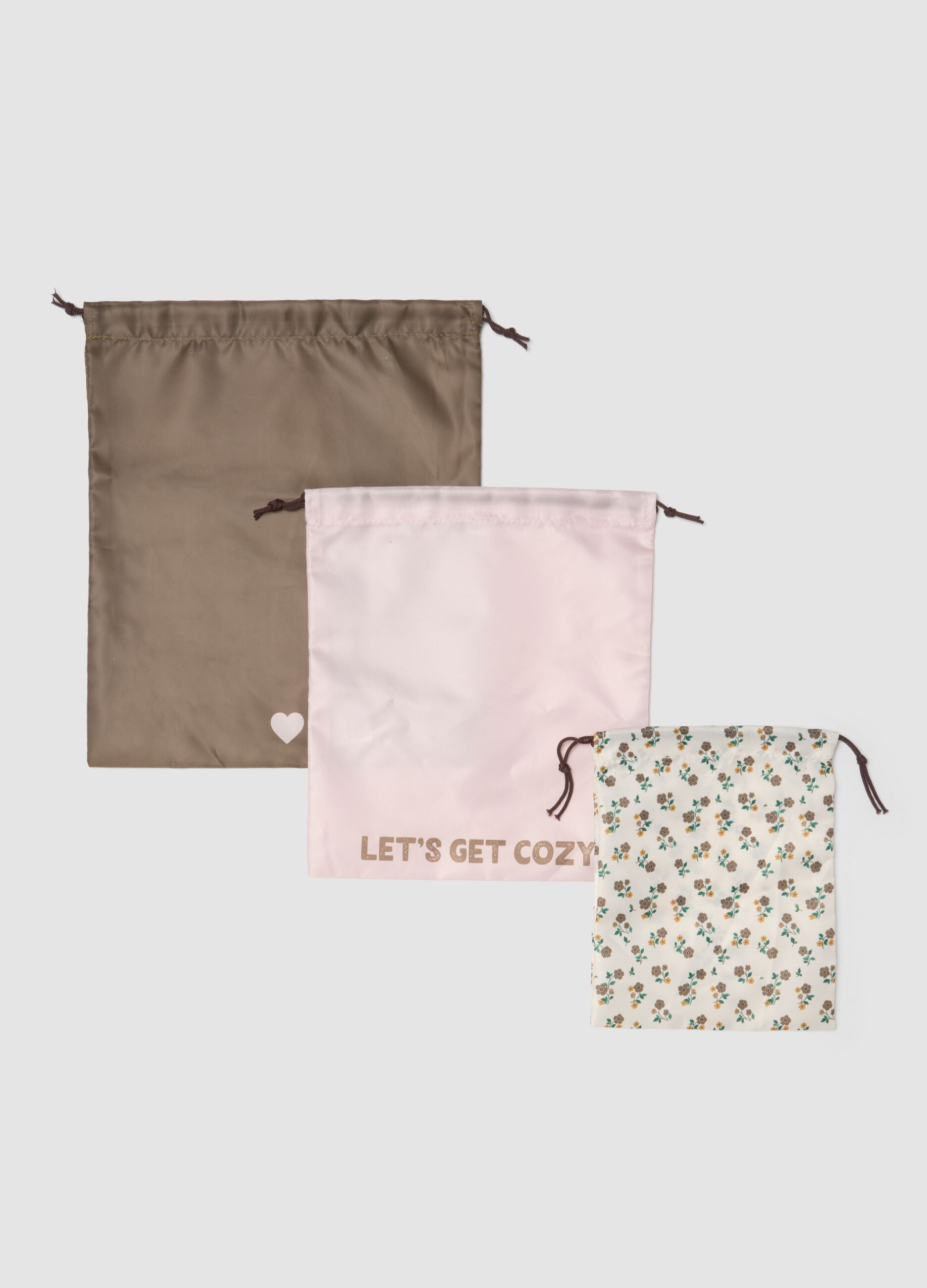 Set of three drawstring pouches in taupe grey, pale pink and off-white