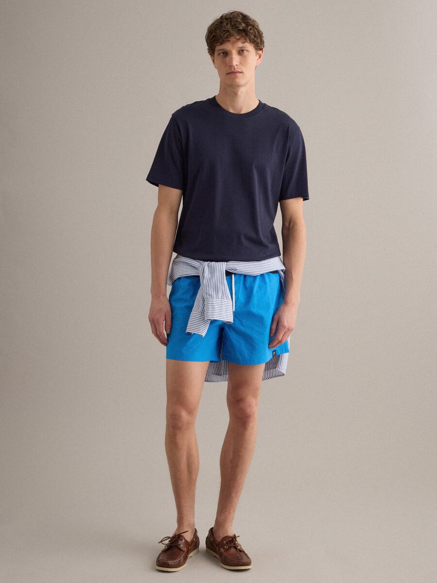 Blue swim shorts with elasticated waistband and contrast drawstring_1