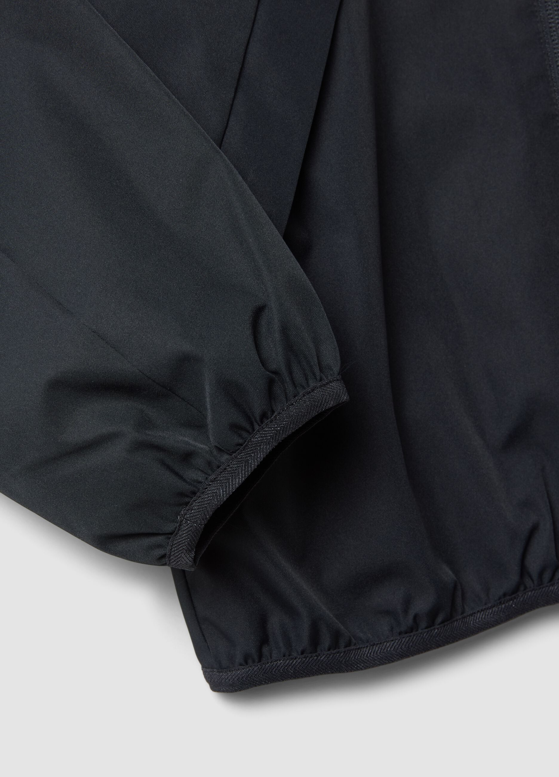 Black oversized rain jacket with hood and zip for boys