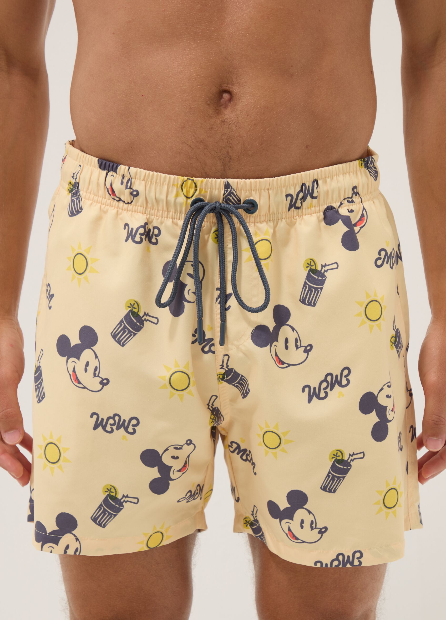 Orange swim trunks with Mickey Mouse prints