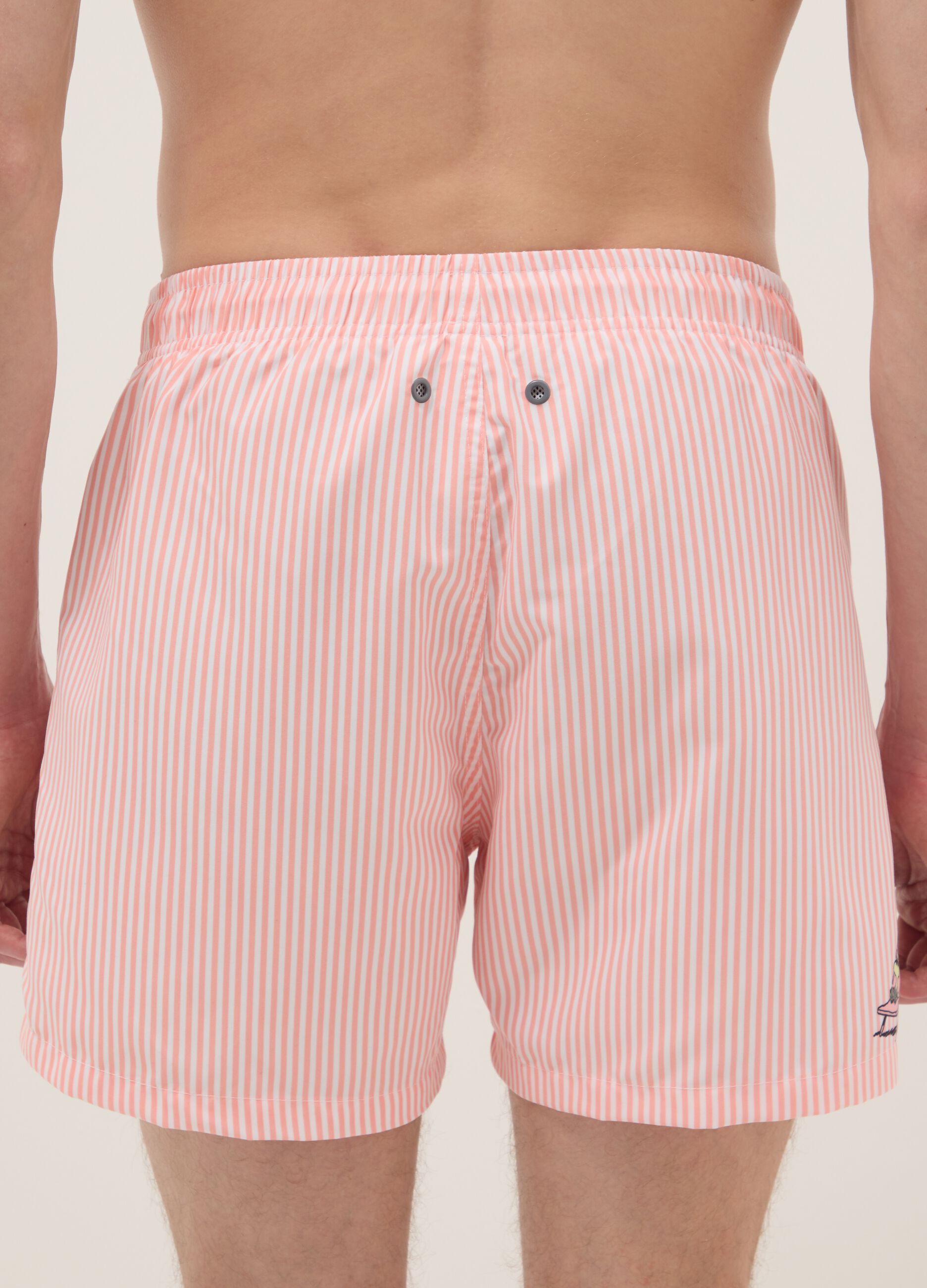 White and pink striped swim trunks with Peanuts print