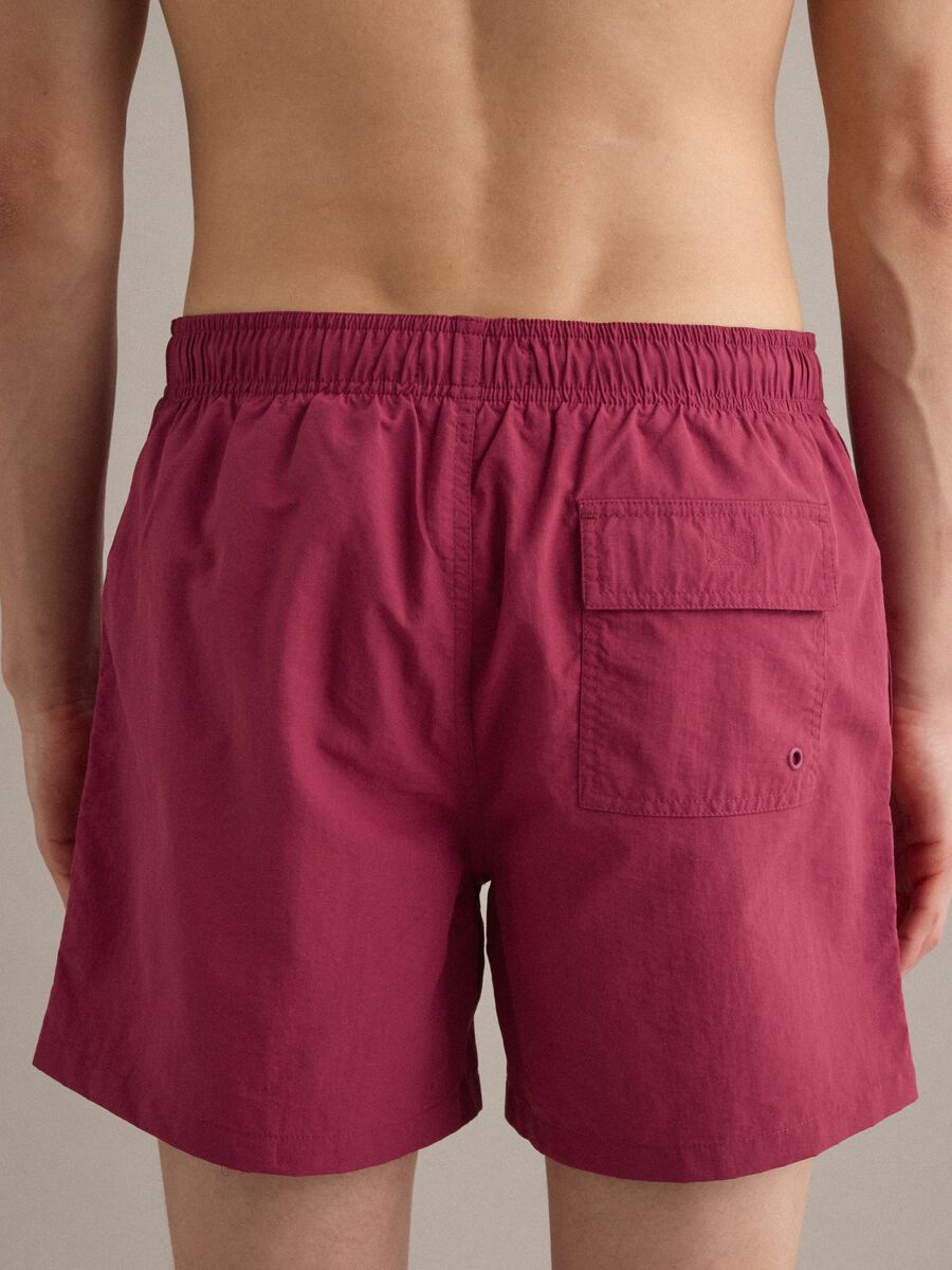 Red swim shorts with elasticated waistband and drawstring_4