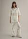 White wide leg cotton blend trousers with perforated texture_1