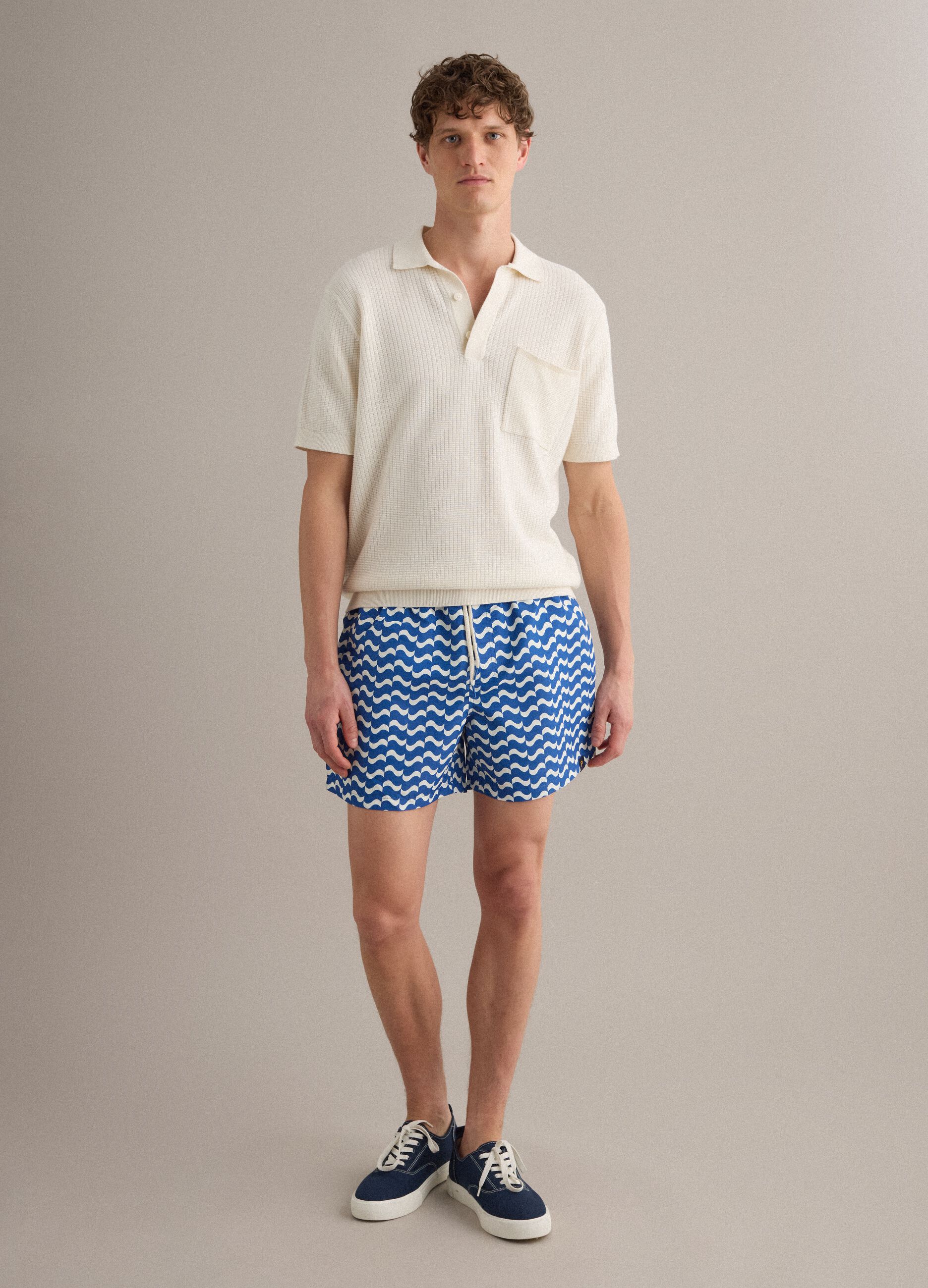 Blue swim shorts with wave pattern