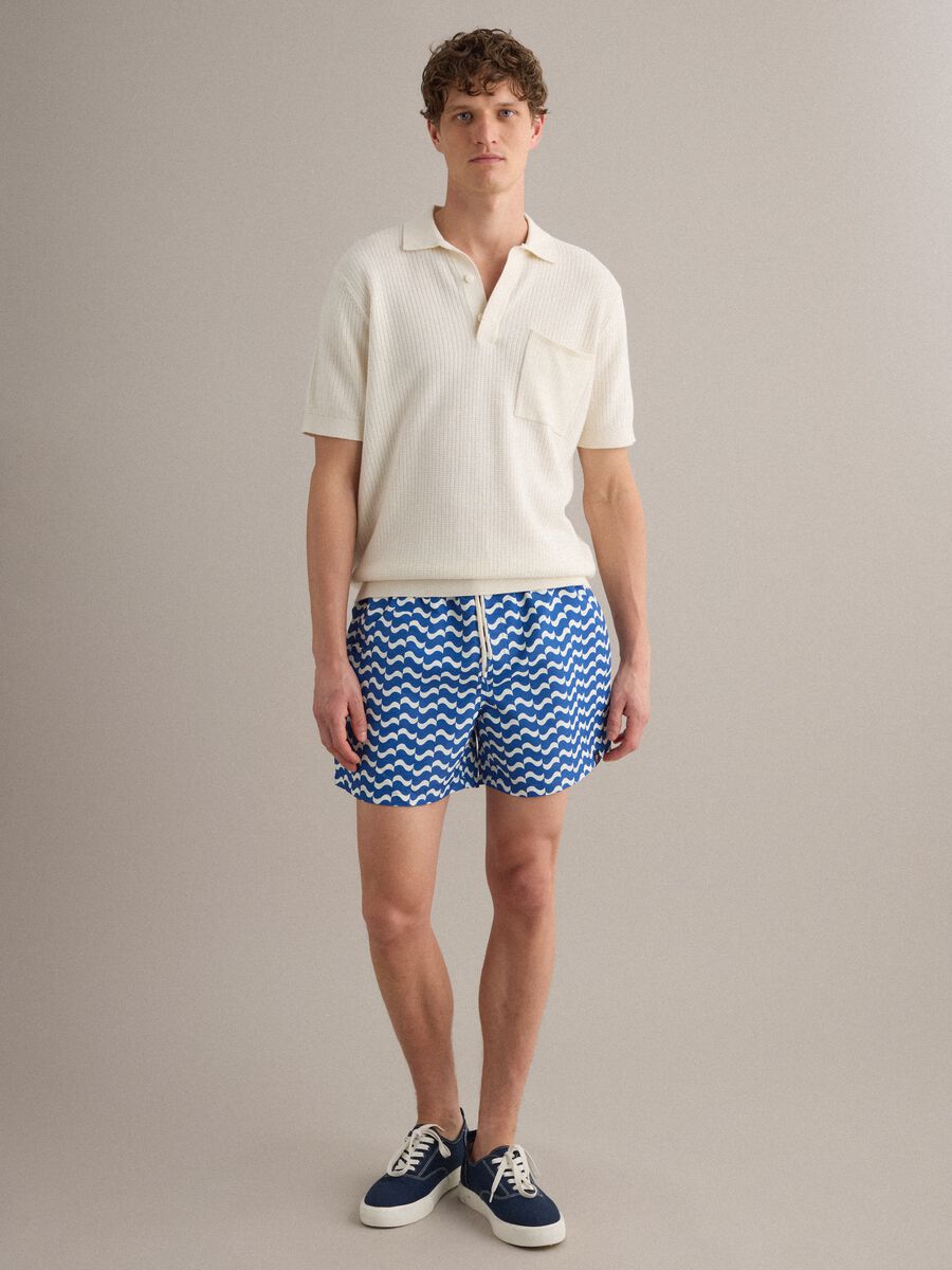 Blue swim shorts with wave pattern_1